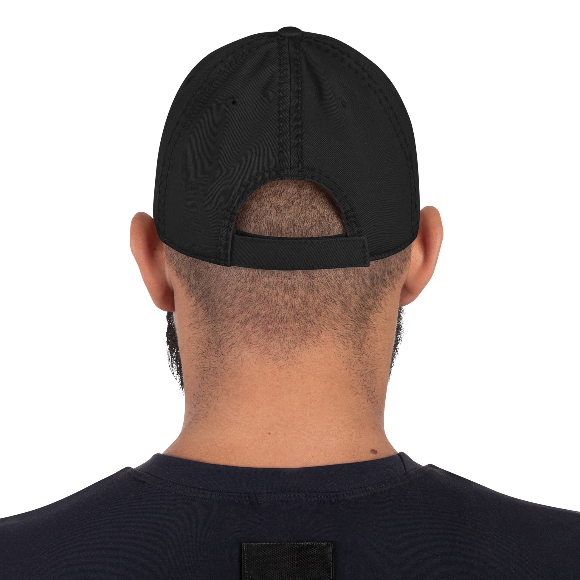 Back view of a man wearing a black distressed dad hat, showcasing the adjustable strap design.