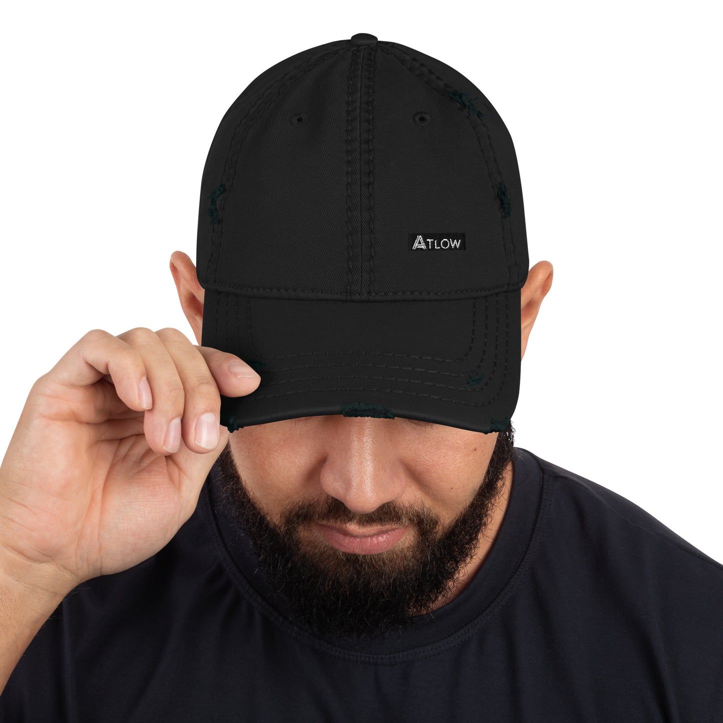 Distressed dad hat in black with ATLOW logo being adjusted by a man, showcasing premium streetwear style.